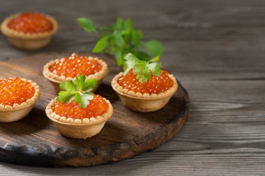 Tartlets ahşap bir masa üzerinde kırmızı havyar