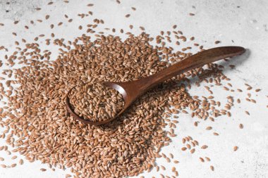 Gri bir tablo üzerinde dağınık keten tohumu. Organik gıda