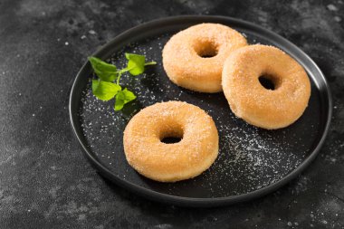 Çörekler şeker serpilir. Koyu arka plan