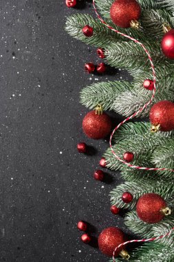 Christmas or New year holiday background with fir branches and red decorations. Top view with copy space