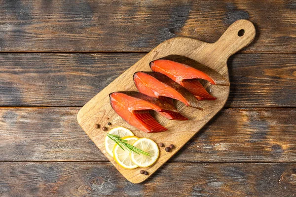 Sockeye salmon. Sockeye steaks on a serving Board on the brown wooden kitchen table. Smoked sockeye salmon on a serving Board. Rustic style. Top view with space for text