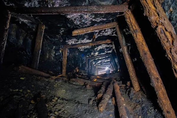 Abandoned coal mine with rotten collapsed wooden miner stands. Old derelict coal development