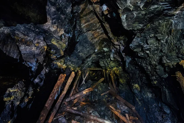 Abandoned coal mine with rotten collapsed wooden miner stands. Old derelict coal development