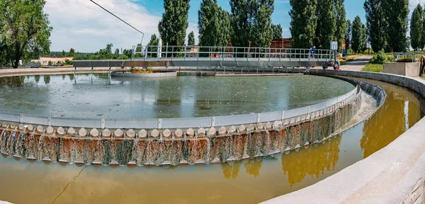 Modern urban sewage treatment plant. Water flowing in round sedi