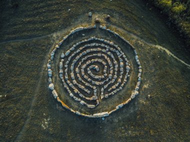 Spiral labyrinth made of stones, top view from drone clipart