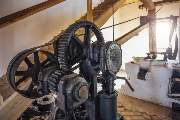 Old mechanism. Old gears and pulleys with belt