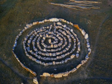 Spiral labyrinth made of stones, top view from drone clipart