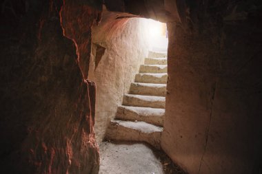 Stairs in old underground chalky cave monastery clipart