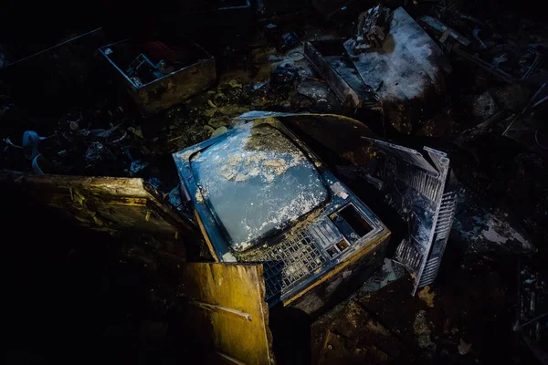 Old broken rotten TV in dark room of abandoned building