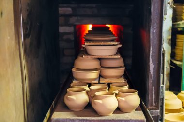 Firing of pottery in the oven clipart