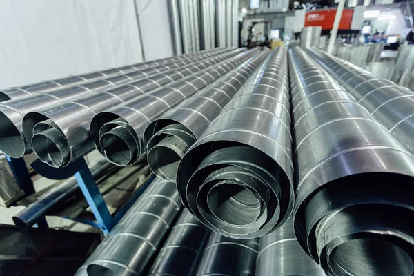 Cylindrical steel pipes. Round metal tubes in metalworking works — Stock Photo, Image