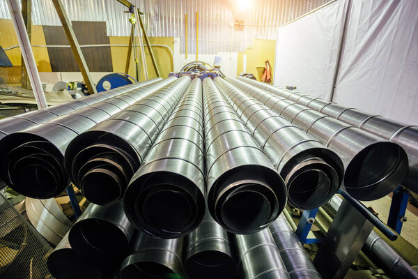 Cylindrical steel pipes. Round metal tubes in metalworking works