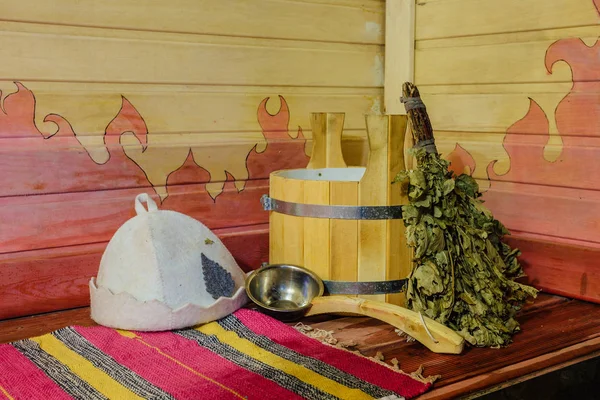 Traditional Russian bath equipment on the wooden bench. Wooden b