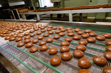 Confectionery factory. Production line of baking cookies. Glazed clipart
