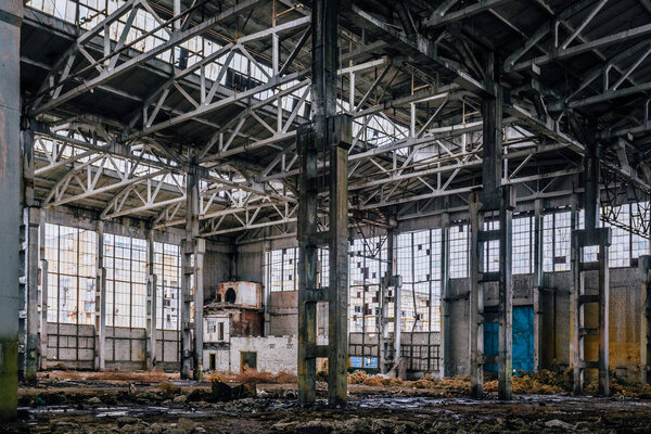 Rotten abandoned large industrial hall with garbage. Voronezh excavator factory.