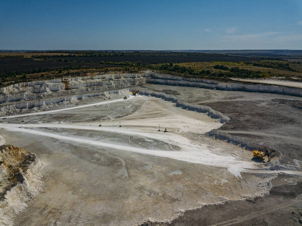 Open chalky quarry, aerial view from drone
