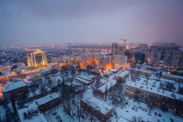 Fog, snowstorm at winter night in Voronezh. Aerial view.