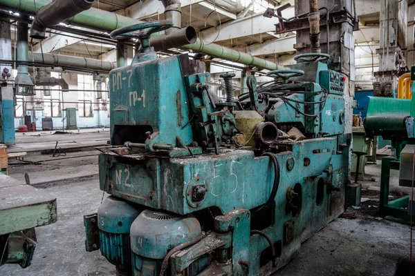 Abandoned tire factory with rusted machine tools