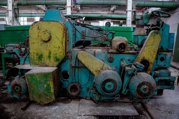 Abandoned tire factory with rusted machine tools
