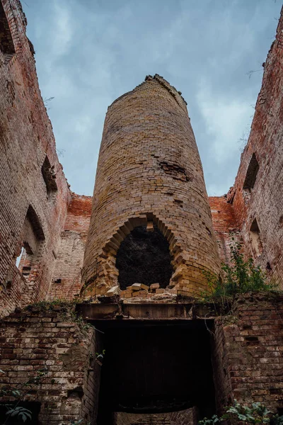 Old industrial furnace ruin in abandoned red brick factory