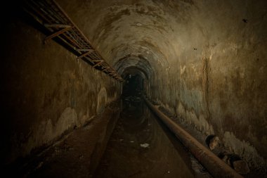 Underground sewer tunnel under Sevastopol, Crimea. Flooded sewer clipart