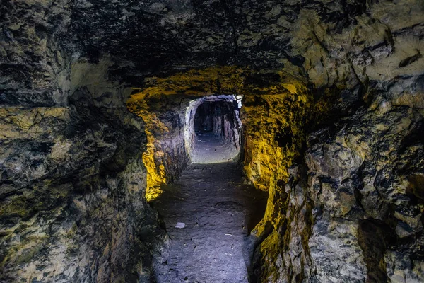 Abandonada e desmoronada mina de arenito ou calcário iluminada — Fotografia de Stock