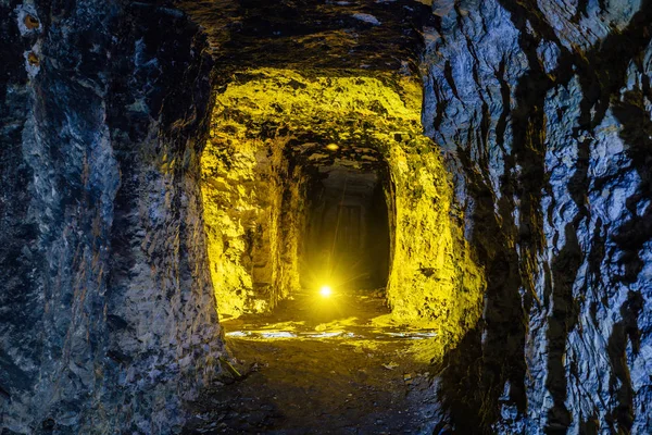 Abandonada e desmoronada mina de arenito ou calcário iluminada — Fotografia de Stock