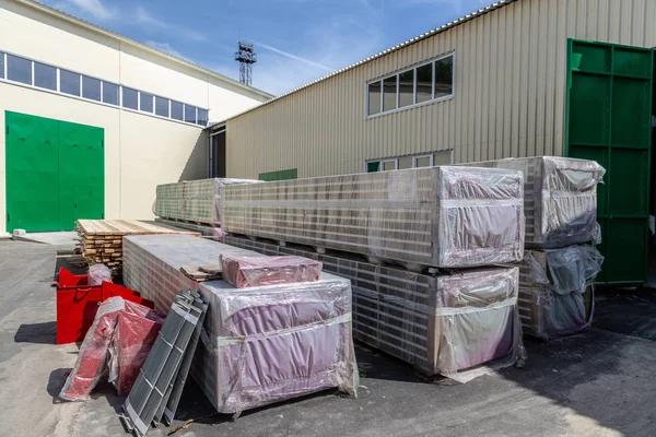 Thermal insulation sandwich panels packed outside warehouse read