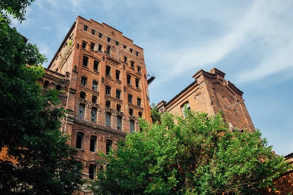 Abandoned factory of red brick - former elevator of factory of b