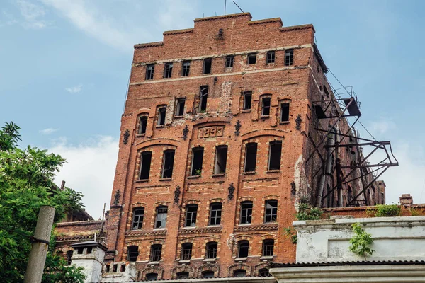 Abandoned factory of red brick - former elevator of factory of b