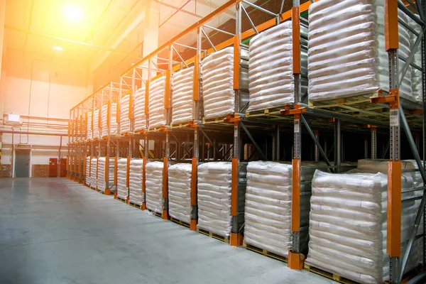 Hangar warehouse with rows of shelves with white polyethylene ba — Stock Photo, Image