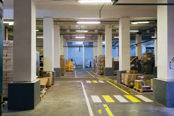 Industrial warehouse interior. Goods in carton and polyethylene — Stock Photo, Image