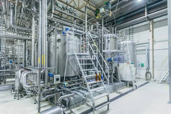 Modern brewery interior. Filtration vats, pipeline, valves and o