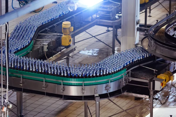 Moderne geautomatiseerde bier bottelen productielijn. Bierflessen mov — Stockfoto