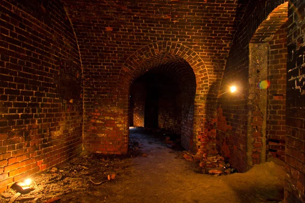 Dungeon under the old Prussian fortress illuminated by candles,