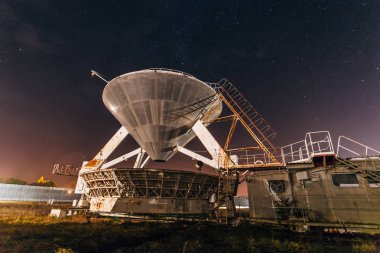 Radio telescope satellite antenna at starry night clipart