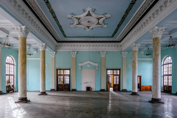 Interior of large column hall with fretwork at abandoned mansion