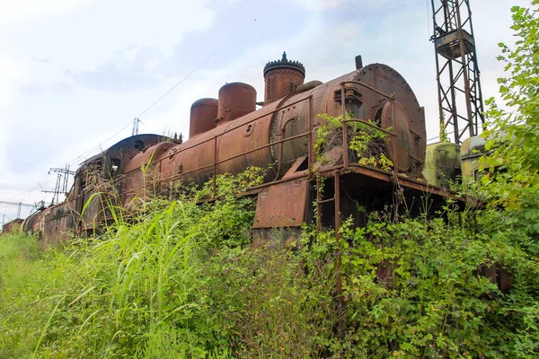 Tren abandonado. Ferrocarril abandonado. Vieja locomotora de vapor oxidada o — Foto de Stock