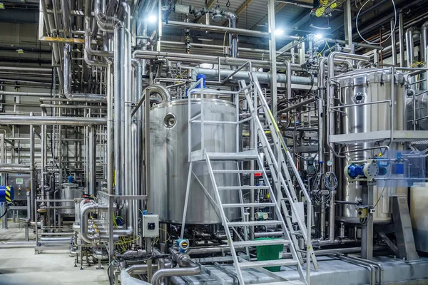 Modern brewery interior. Filtration vats, pipeline, valves and o