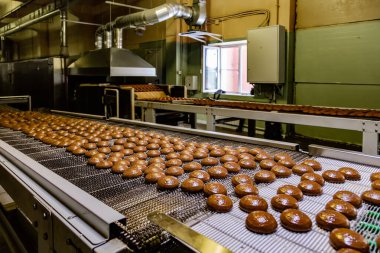 Confectionery factory. Production line of baking cookies. Glazed clipart