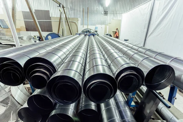 Cylindrical steel pipes. Round metal tubes in metalworking works — Stock Photo, Image