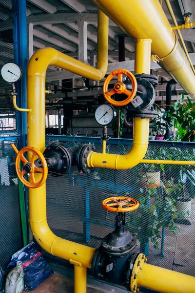 Steel industrial pipeline with valves and manometers in boiler room