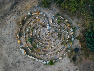 Spiral labyrinth made of stones, top view from drone. clipart
