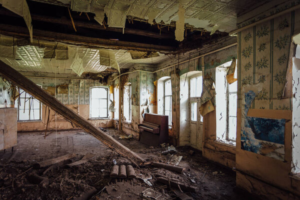 Abandoned school interior, dirty room, rotten peeled walls.