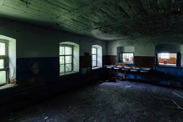 Abandoned school interior, dirty room, rotten peeled walls.
