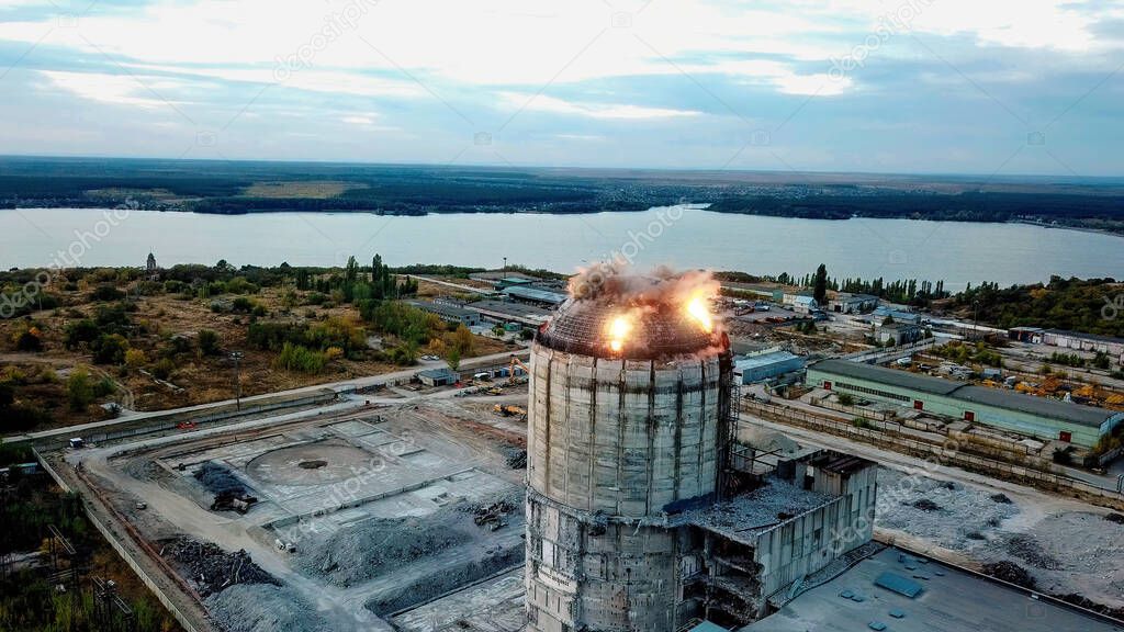 Demolition of old industrial building by exploding dynamite, aerial view.