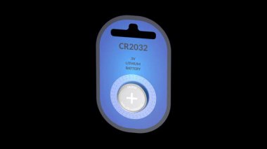CR2032 lithium button cell battery in blister pack on black background