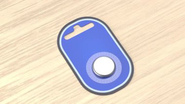Button cell battery in blister pack on wooden desk