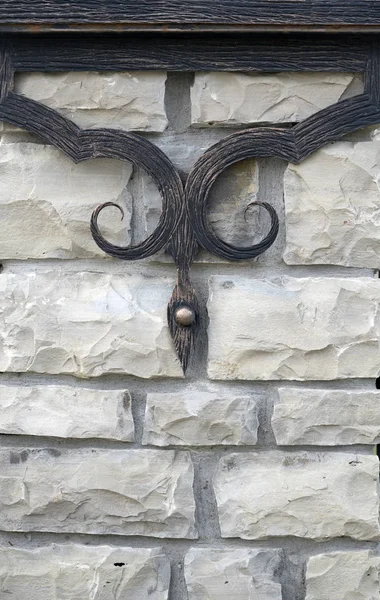 forged product on a brick wall