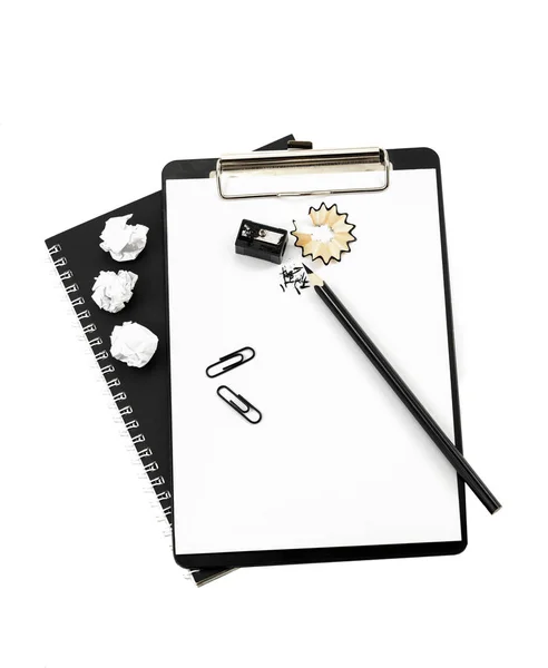 Sharpened pencil and notebook on a white background